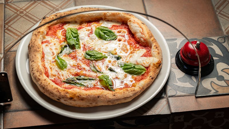 Classic Margherita pizza with fresh basil and mozzarella